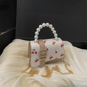 Mini cherry print bag with pearl handle and golden chain, elegant small crossbody style