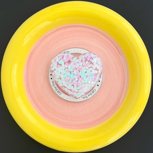 Macro shot of heart-shaped MagSafe phone holder filled with colorful macaron sequins