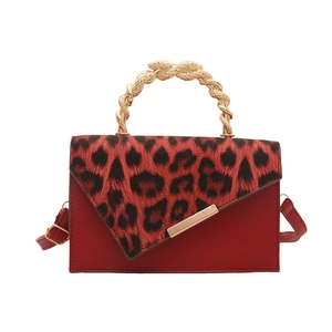 Red leopard print shoulder bag with a unique gold metal spiral top handle and leather strap
