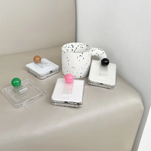 Detail of colorful spherical ring holders on transparent Samsung Galaxy Z Flip phone cases