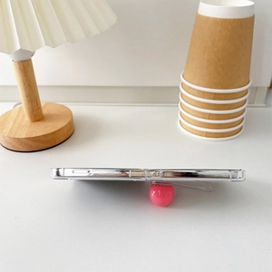Detail of transparent Galaxy Z Flip case featuring a 3D pink spherical handle and precise cutouts