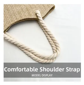Detailed close-up of straw woven tote bag featuring beige cotton rope handles and fine texture