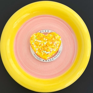 Detail of glitter-filled resin heart phone grip on a white Gift For You card tray