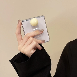 Close-up of clear folding phone case with cream spherical grip and transparent ring