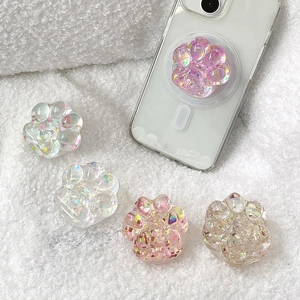 Detailed view of sparkling 3D cat paw phone grips with colorful glitter and sequins.