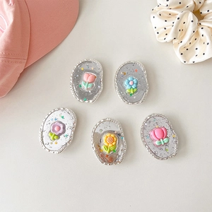 Macro view of five 3D tulip floral expanding phone grips in various pastel colors