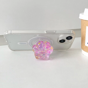 Detailed close-up showing a glittering pink cat paw collapsible phone grip stand