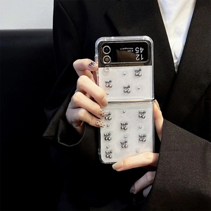 Detail of transparent Z Flip6 case with 3D silver bow and beads on a folding phone