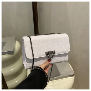 Close-up of white crocodile pattern PU leather bag with dark gunmetal chain and hardware