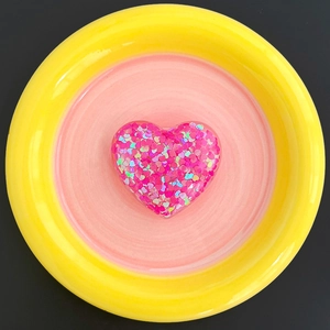 Close-up of pink glitter heart phone socket with sparkling sequins and resin finish