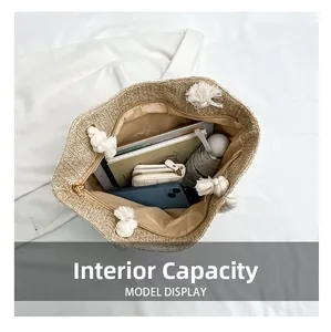 Large capacity interior of a straw woven tote bag holding a tablet, wallet and umbrella