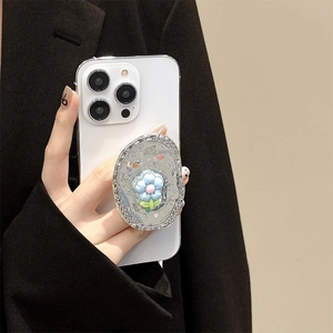 Hand holding phone with a 3D floral glitter pop socket featuring blue tulip relief
