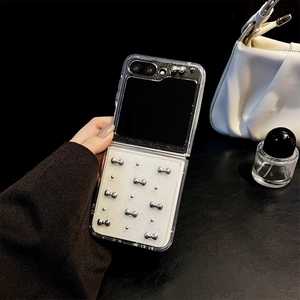 Detail of glitter folding phone case for Galaxy Z Flip with silver metal bow accents