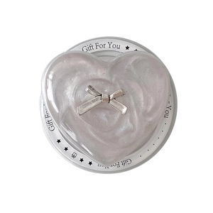 Pearlescent heart phone grip with silver bow on Gift For You card background