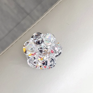 Detailed view of cat paw shaped phone socket with iridescent holographic glitter filler.