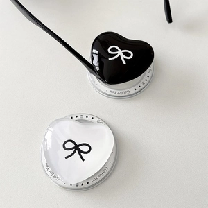 Detail of heart-shaped magnetic phone sockets with bow patterns and mirror resin finish