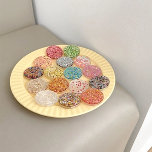 Detail shot of colorful glitter and sequin patterns on round telescopic phone grips