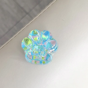 Close-up of an iridescent glitter cat paw retractable phone grip with a holographic finish