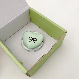 Macro view of a mint green heart phone socket with bow detail in Gift For You box