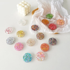 Variety of glitter resin phone grips in colorful sparkling heart and star patterns