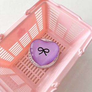 Purple heart magnetic phone stand with black bow on pink shopping basket background