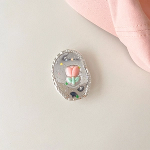 Close-up of pink 3D tulip phone grip with glitter silver frame and mirrored surface