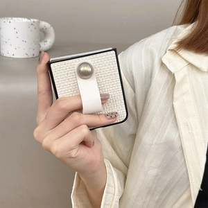 Detail of woven texture phone case for Galaxy Z Flip with white leather finger strap