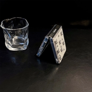Detail view of transparent Z Flip phone case with nine silver 3D metal bear charms