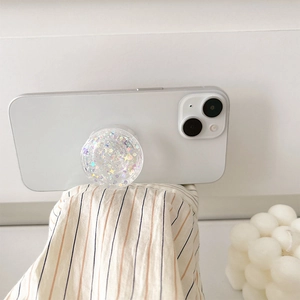 Sparkly glitter collapsible phone grip with colorful sequins on a sleek white smartphone