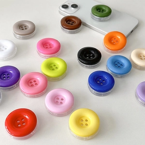 Colorful button-shaped phone grip sockets for desk stand use on various smartphones