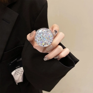 Close-up of sparkling silver glitter phone grip held in hand with holographic sequins