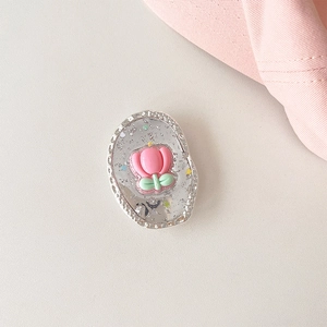 Detail of pink tulip flower phone grip with silver glitter flakes on white texture