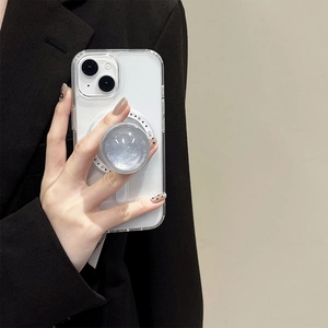 Detail of transparent phone case with silver glitter magnetic collapsible socket stand