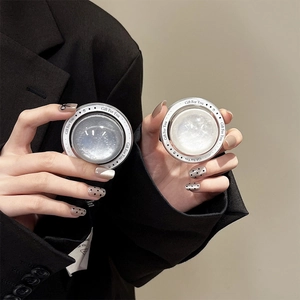 Close-up of crystal dome phone stands in shimmering silver and white with star patterns