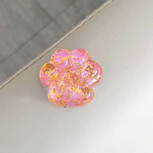 Close-up detailed view of a sparkling pink cat paw retractable phone socket grip accessory.