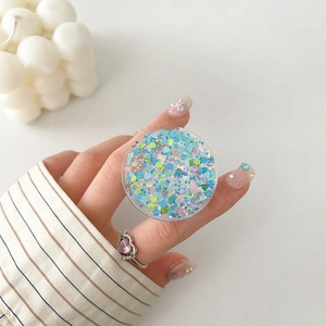 Detail of expandable round phone grip with mixed colorful glitter and heart sequins