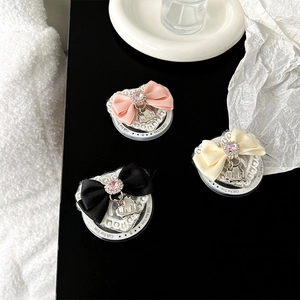 Detailed view of heart-shaped lace phone grips with silk bows and crystal accents