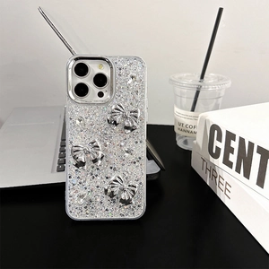 Detail of silver glitter iPhone case with metallic bows and sparkling waterdrop rhinestones