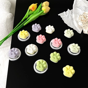 Vibrant 3D cat paw phone grip sockets in pastel macaron colors displayed on black