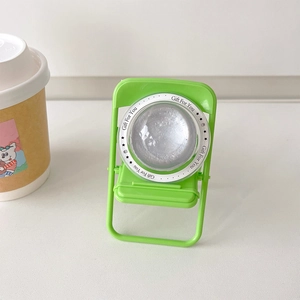 Detail of creative mini chair phone stand in bright green with silver glitter ornament