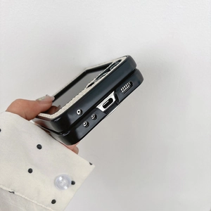Detail view of foldable phone case with black leather texture and white braided edges