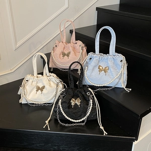 Textured drawstring bucket bags with butterfly details and pearl chains in four colors