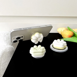 Close-up detail of a cute 3D cat paw magnetic phone socket stand on a white smartphone