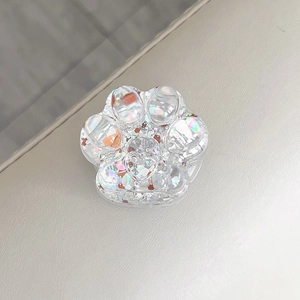 Detailed view of holographic glitter cat paw expandable phone grip with 3D design.