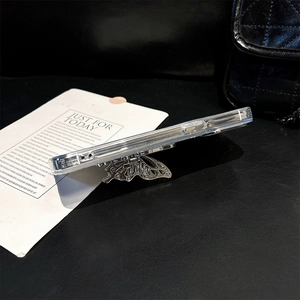 Detail of transparent iPhone case featuring a hollow silver butterfly ring holder on the side