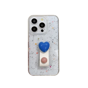 Transparente iPhone Hülle mit Silberglitzer und blauem Herz-Griff auf Lederarmband