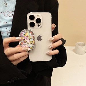 Close-up of glitter heart phone socket with rhinestones on a white phone case