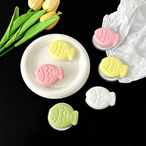 Macro view of colorful fish-shaped phone holders with scale texture on a plate