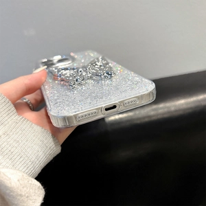 Detail shot of a silver butterfly kickstand on a glittery iPhone case with precise cutouts