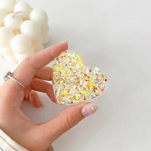 Detail of heart-shaped phone griptok with yellow glitter and iridescent sequins